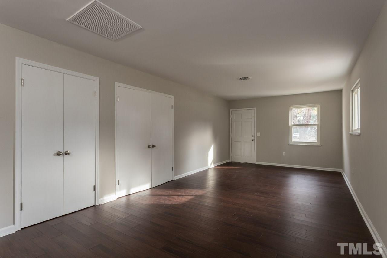 2708 Sanderford Road Raleigh, NC 27610 - Photo 11 of 21 an empty room with wooden floor and windows