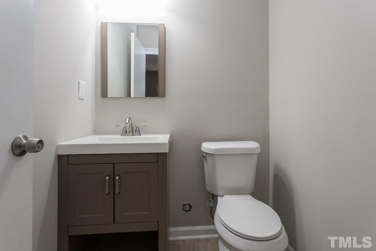 2708 Sanderford Road Raleigh, NC 27610 - Photo 17 of 21 a bathroom with a toilet sink and mirror