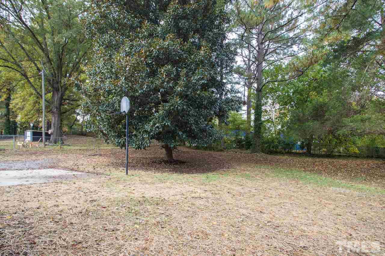 2708 Sanderford Road Raleigh, NC 27610 - Photo 20 of 21 a backyard of a house with lots of trees