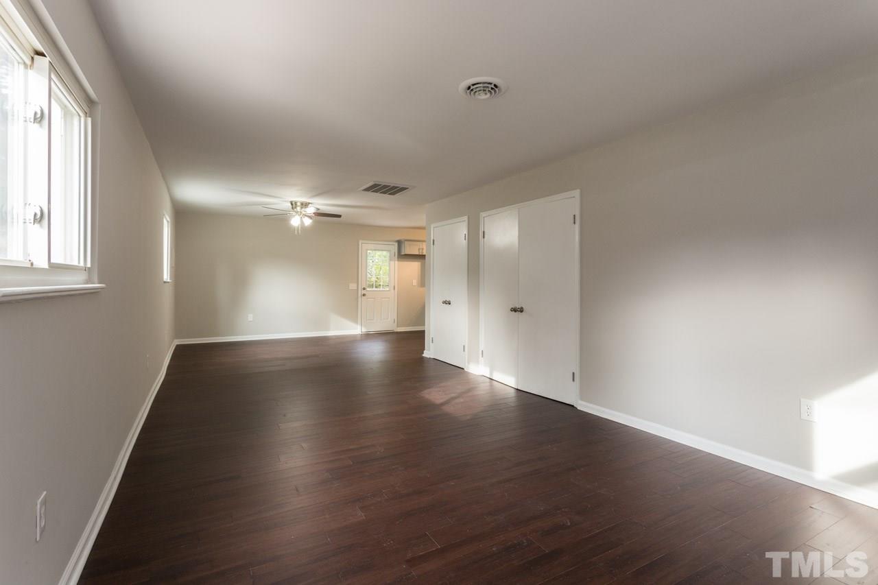2708 Sanderford Road Raleigh, NC 27610 - Photo 3 of 21 an empty room with wooden floor and windows