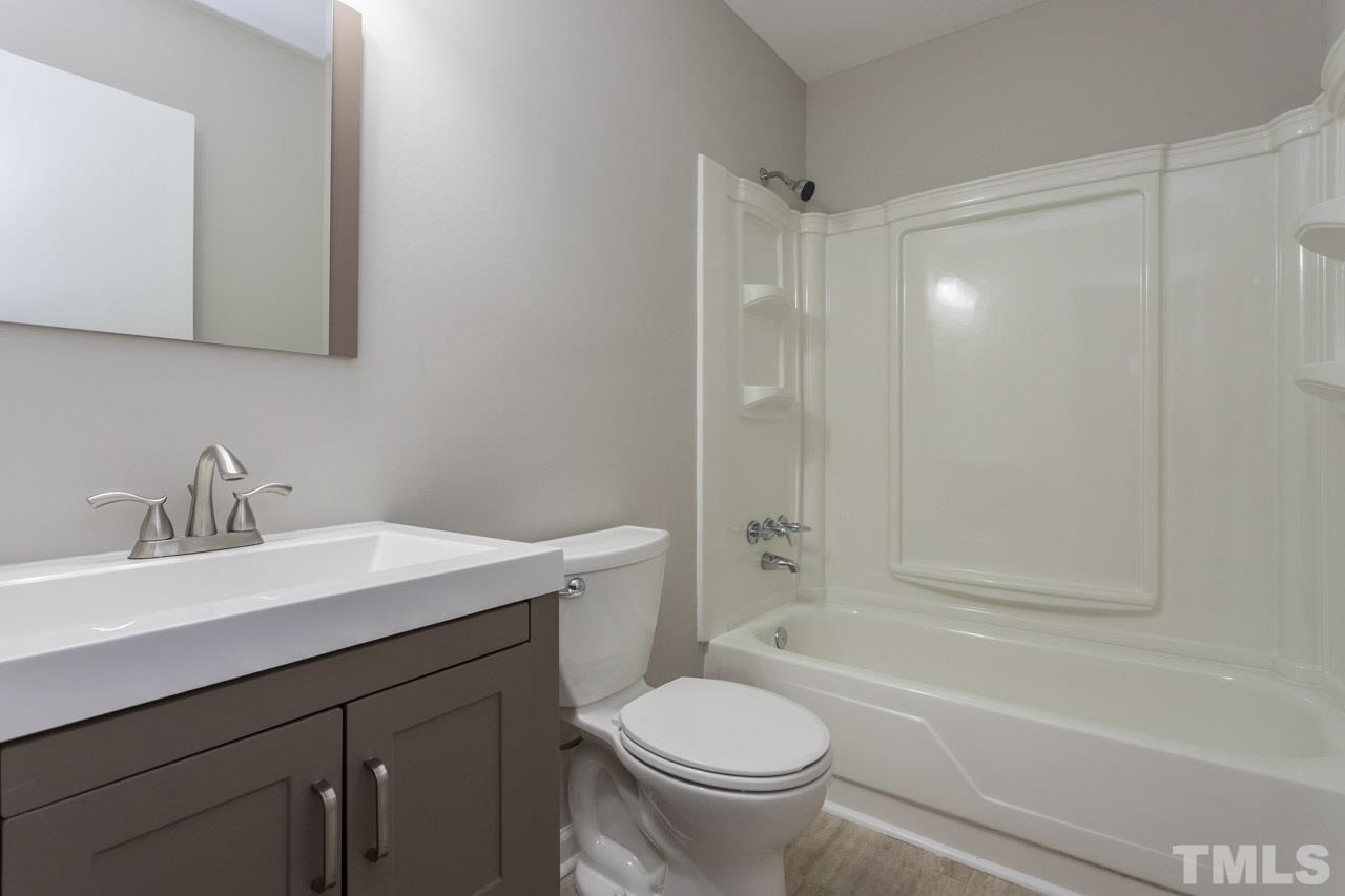 2708 Sanderford Road Raleigh, NC 27610 - Photo 6 of 21 a bathroom with a sink toilet vanity and bathtub