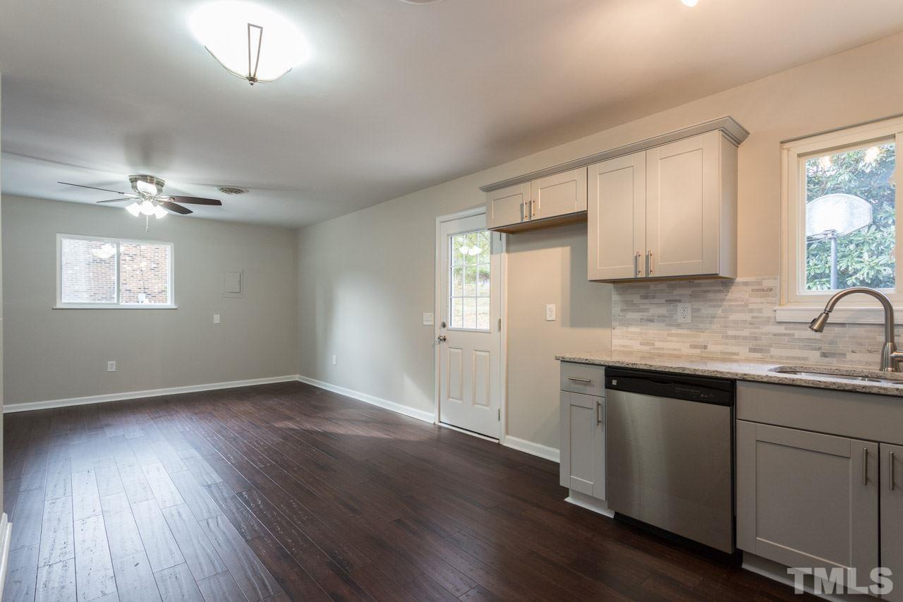 2708 Sanderford Road Raleigh, NC 27610 - Photo 8 of 21 a view of an empty room with wooden floor and a window