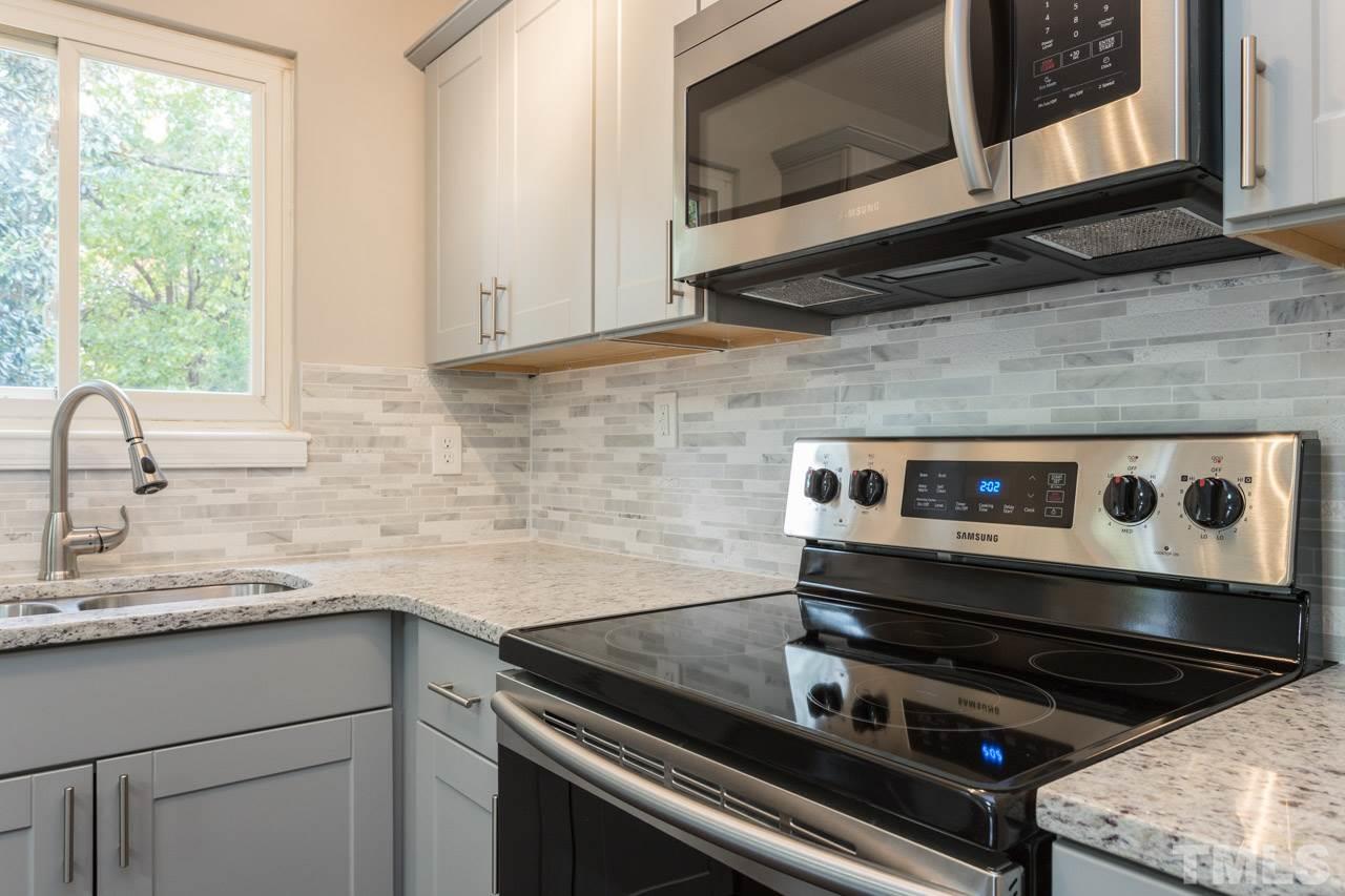 2708 Sanderford Road Raleigh, NC 27610 - Photo 9 of 21 a kitchen with a stove microwave and sink