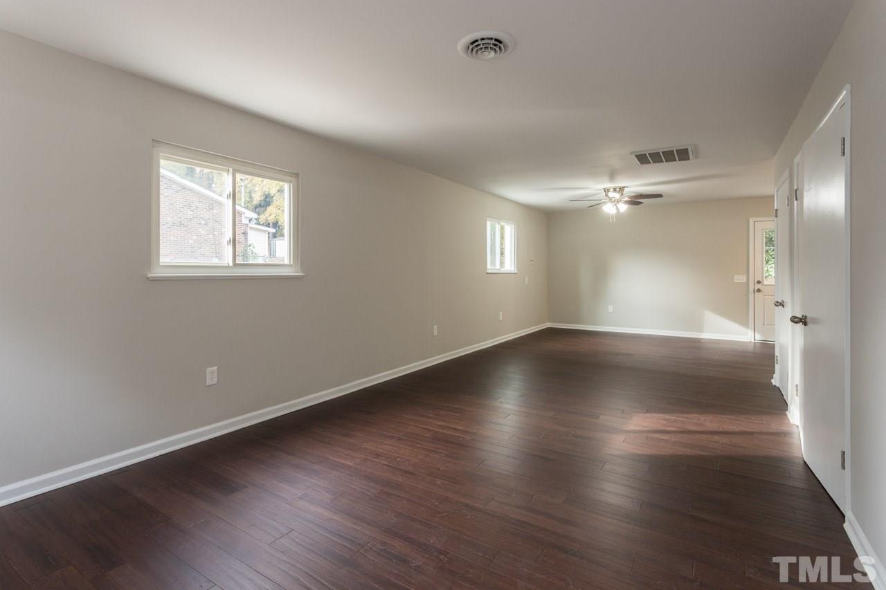 2708 Sanderford Road Raleigh, NC 27610 - Photo 10 of 21 an empty room with wooden floor and windows