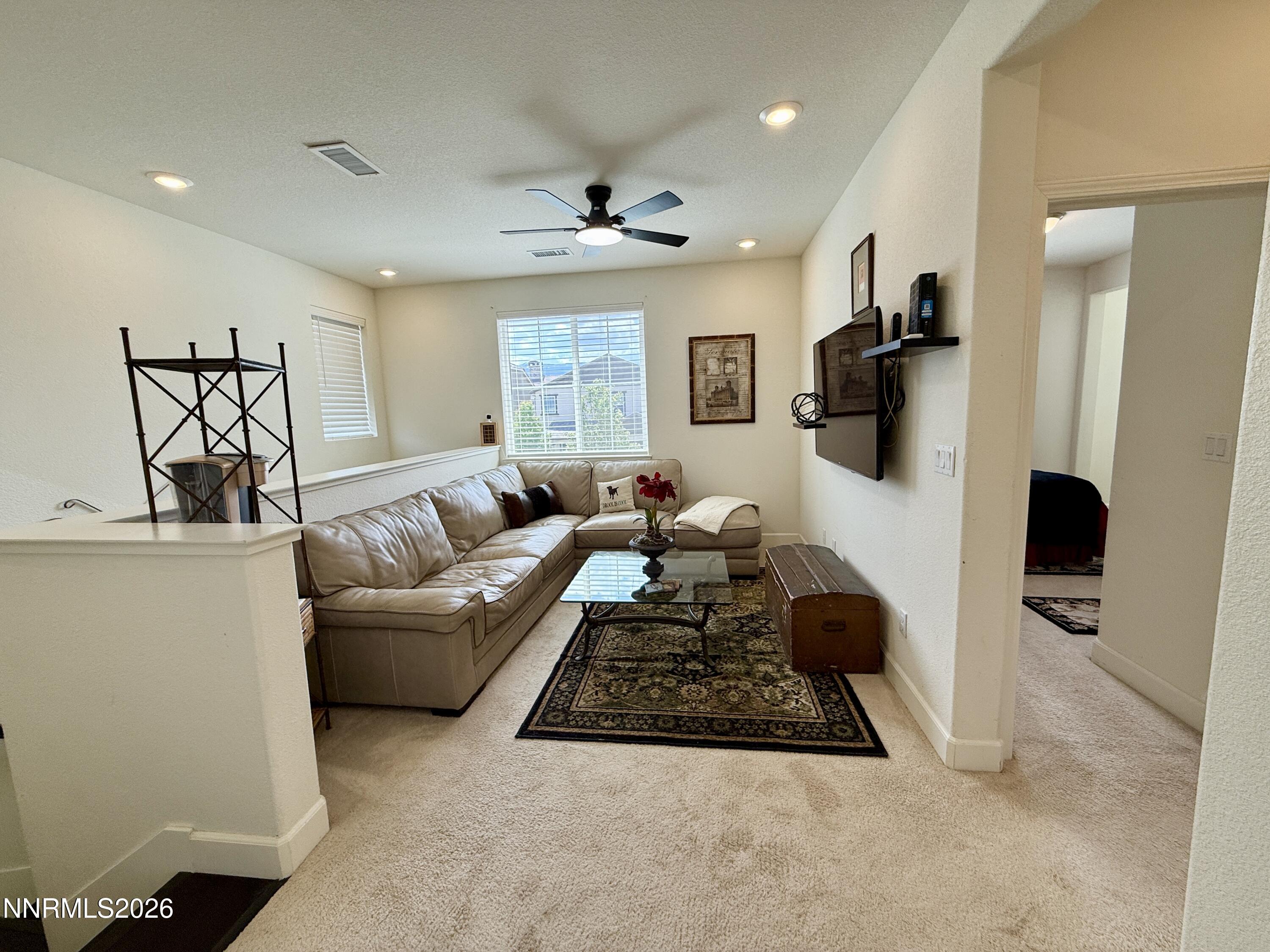 9766 Pachuca Drive Reno, NV 89521 - Photo 22 of 59 a living room with furniture rug and a window