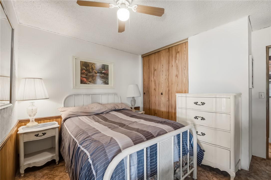 10031 Dike Road Mohave Valley, AZ 86440 - Photo 63 of 78 a bedroom with a bed and a chandelier