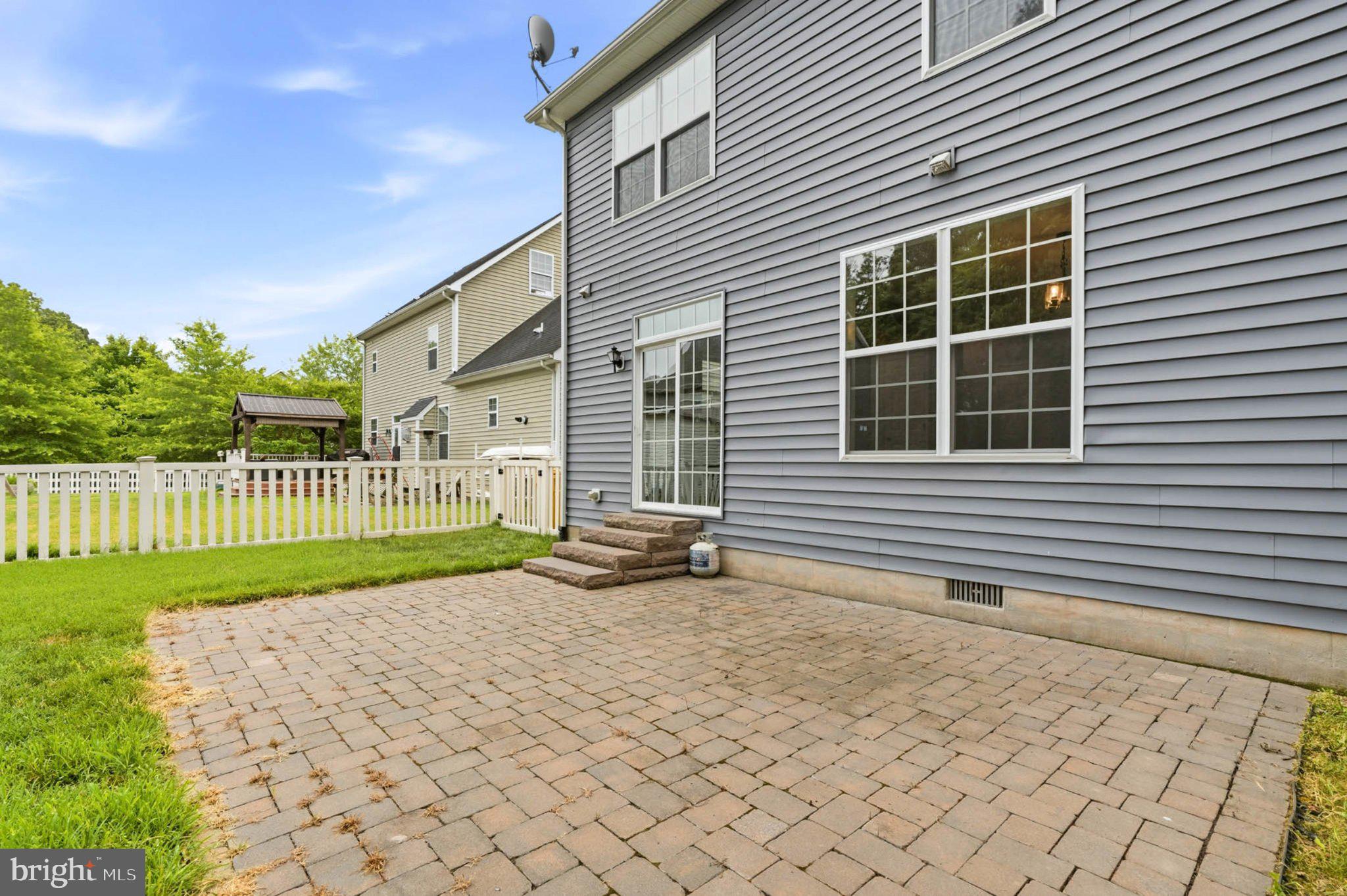 706 Trapper Way Deale, MD 20751 - Photo 50 of 61 Charming patio with lush greenery.