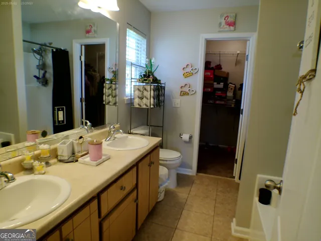 a bathroom with a sink double vanity and a mirror