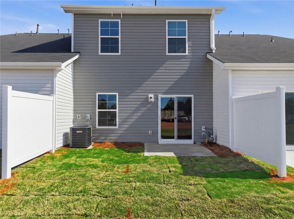 319 Lilac Loop Greenwood, SC 29649 - Photo 25 of 25 The rear exterior features new sod, a patio, and vinyl siding.