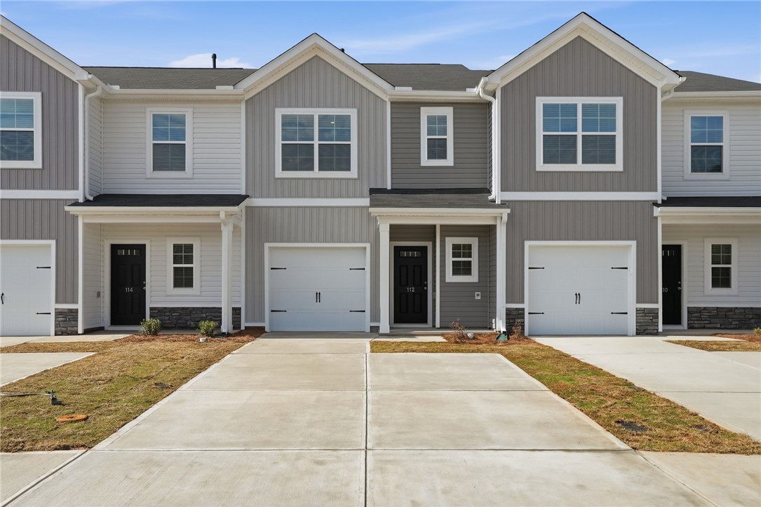 319 Lilac Loop Greenwood, SC 29649 - Photo 4 of 25 This newly built row of townhomes offers convenient living with individual garages and inviting entrances.
