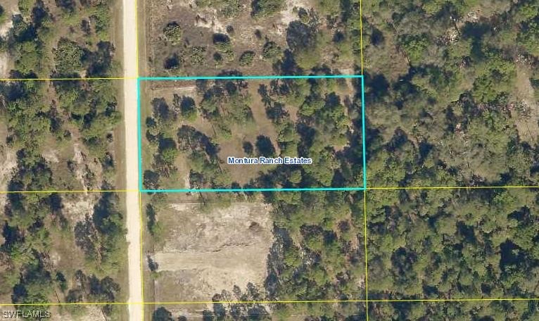 555 North Kennel Street Montura Ranches, FL 33440 - Photo 9 of 14 an aerial view of a house with a yard and mountain view
