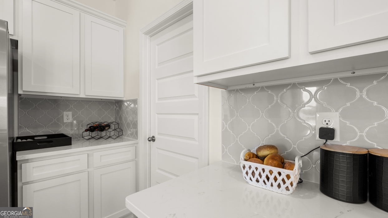 11933 Aukerman Way Hampton, GA 30228 - Photo 12 of 41 a kitchen with stainless steel appliances cabinets and a window
