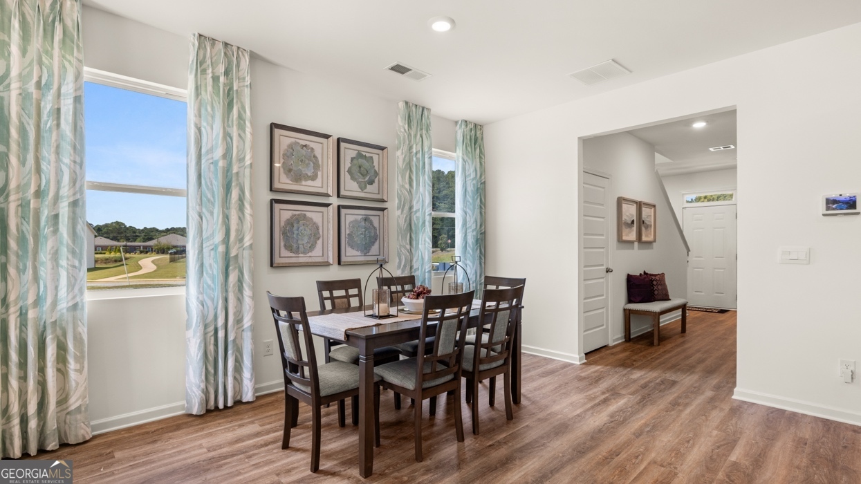 11933 Aukerman Way Hampton, GA 30228 - Photo 13 of 41 a view of a dining room with furniture and wooden floor