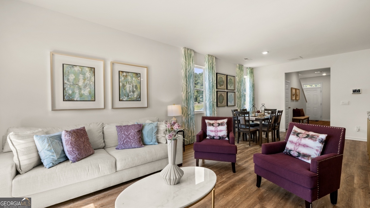 11933 Aukerman Way Hampton, GA 30228 - Photo 17 of 41 a living room with furniture and a large window