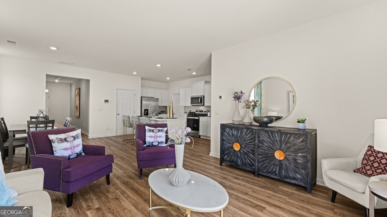 11933 Aukerman Way Hampton, GA 30228 - Photo 18 of 41 a living room with furniture and a fireplace