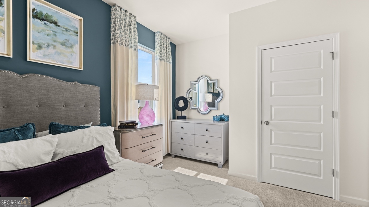 11933 Aukerman Way Hampton, GA 30228 - Photo 20 of 41 a bedroom with a bed and window