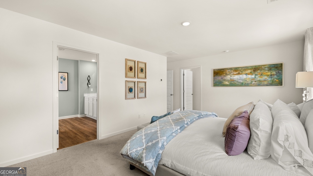 11933 Aukerman Way Hampton, GA 30228 - Photo 29 of 41 a bedroom with a bed and a couch