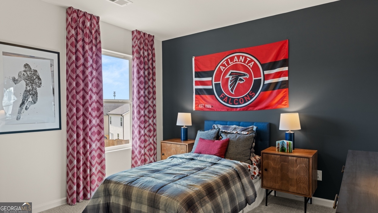 11933 Aukerman Way Hampton, GA 30228 - Photo 34 of 41 a bedroom with a bed and a painting on the wall