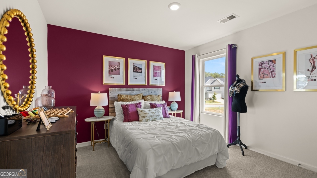 11933 Aukerman Way Hampton, GA 30228 - Photo 36 of 41 a bedroom with a bed and a potted plant