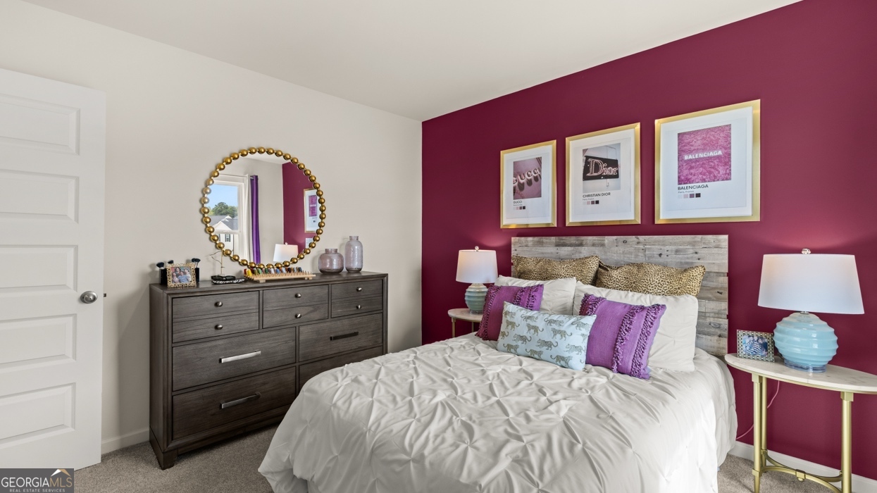 11933 Aukerman Way Hampton, GA 30228 - Photo 37 of 41 a bedroom with a bed and a mirror on dresser