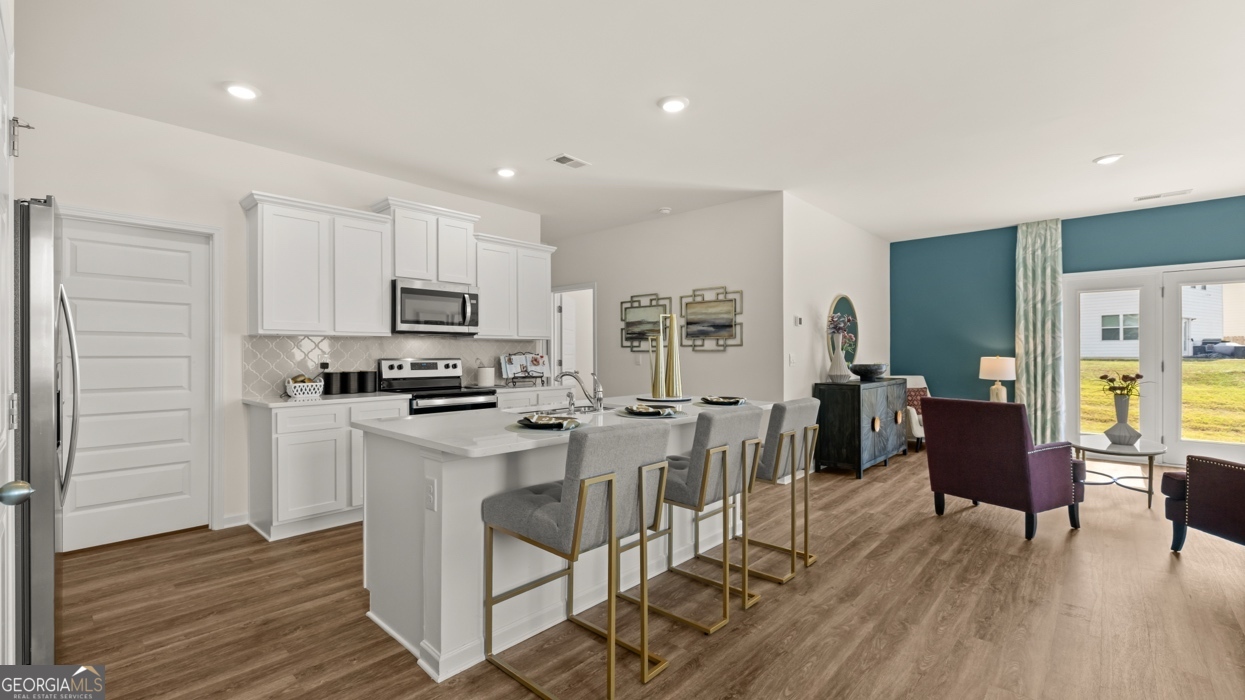 11933 Aukerman Way Hampton, GA 30228 - Photo 6 of 41 a view of kitchen with cabinets and wooden floor