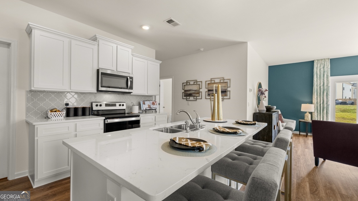 11933 Aukerman Way Hampton, GA 30228 - Photo 9 of 41 a kitchen with furniture a sink and appliances