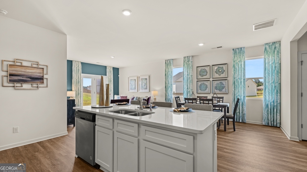 11933 Aukerman Way Hampton, GA 30228 - Photo 10 of 41 a kitchen with sink refrigerator and cabinets