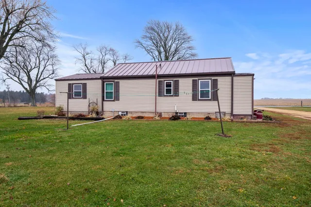 a front view of house with yard and trees
