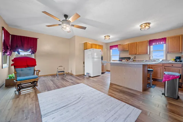 a living room with kitchen island furniture and a wooden floor
