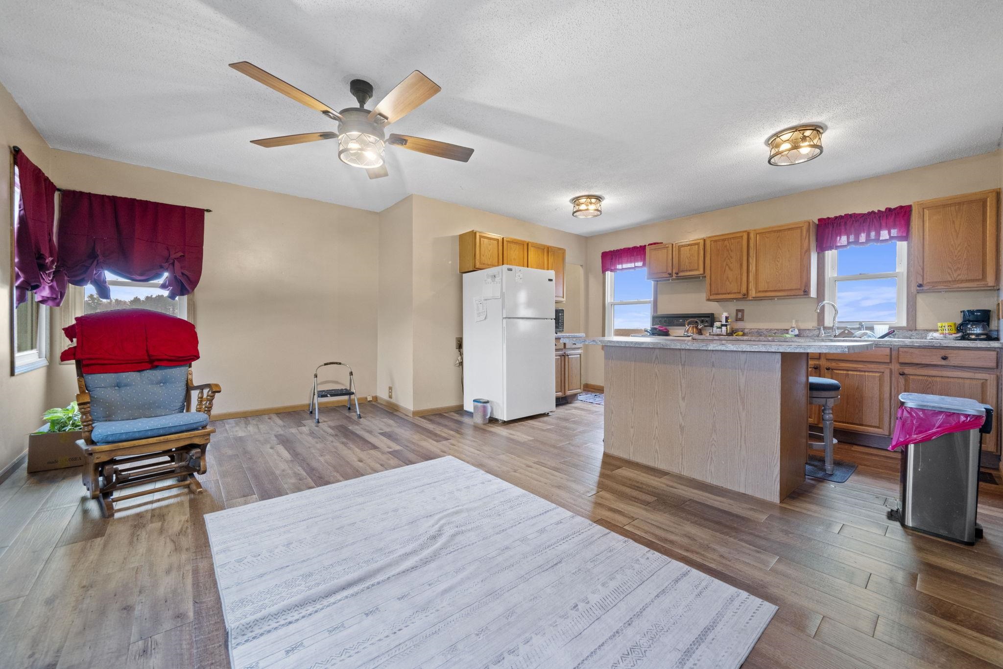 1684 North Mt Morris Road Mount Morris, IL 61054 - Photo 18 of 44 a living room with kitchen island furniture and a wooden floor
