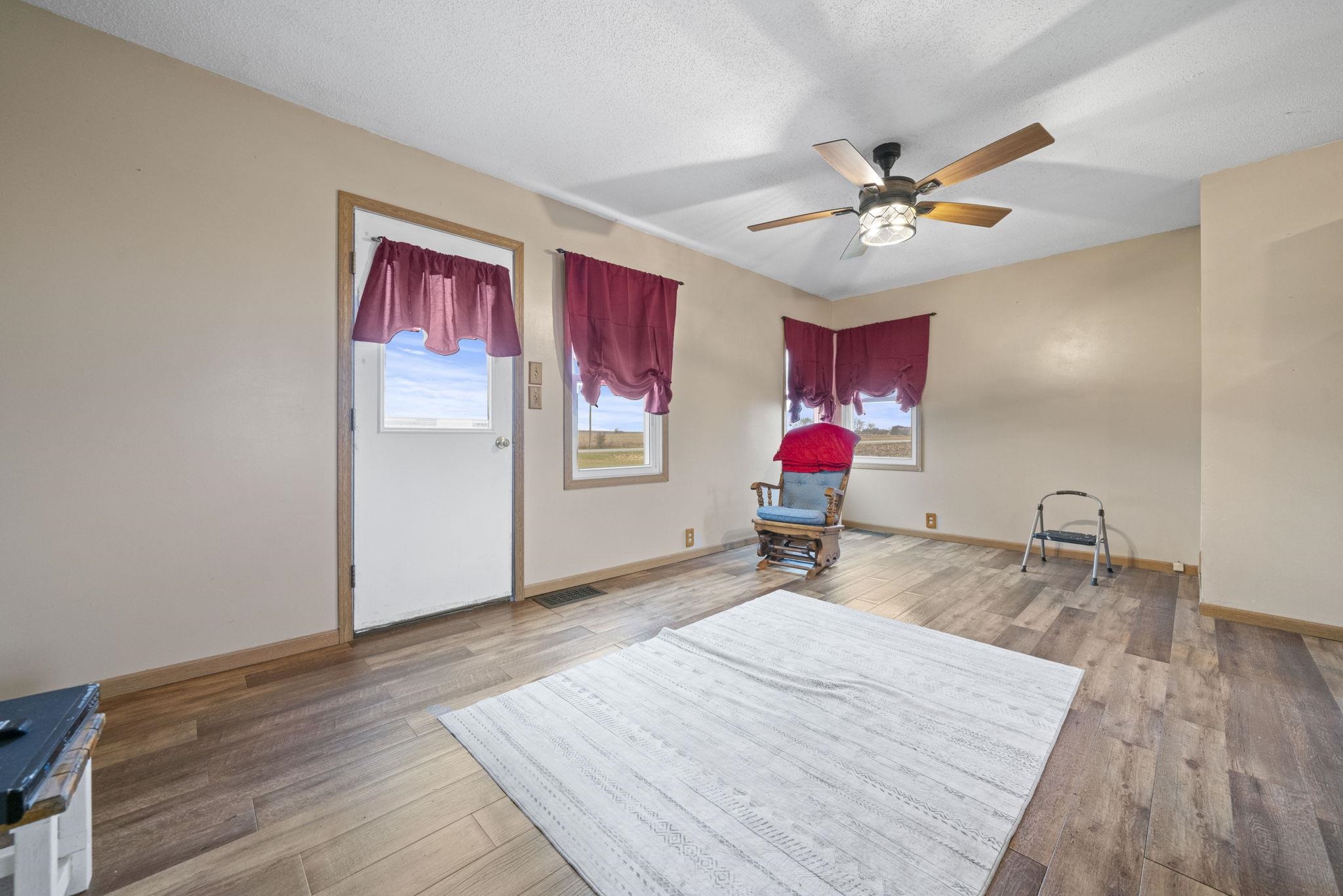 1684 North Mt Morris Road Mount Morris, IL 61054 - Photo 19 of 44 a room with wooden floor and ceiling fan