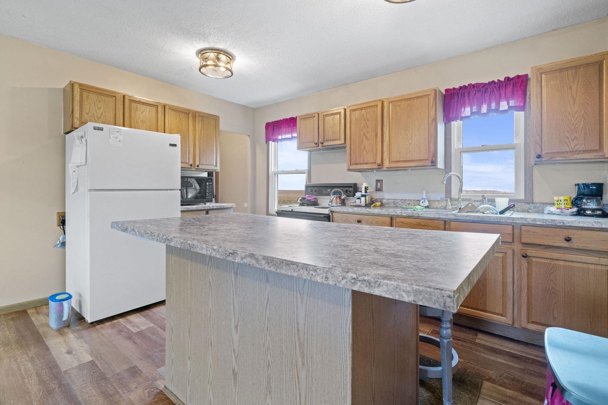 1684 North Mt Morris Road Mount Morris, IL 61054 - Photo 20 of 44 a kitchen with granite countertop a sink a counter top space and cabinets