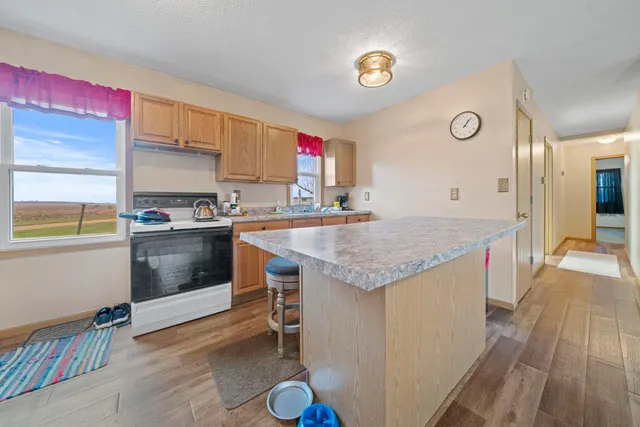 a kitchen with a sink stove and cabinets