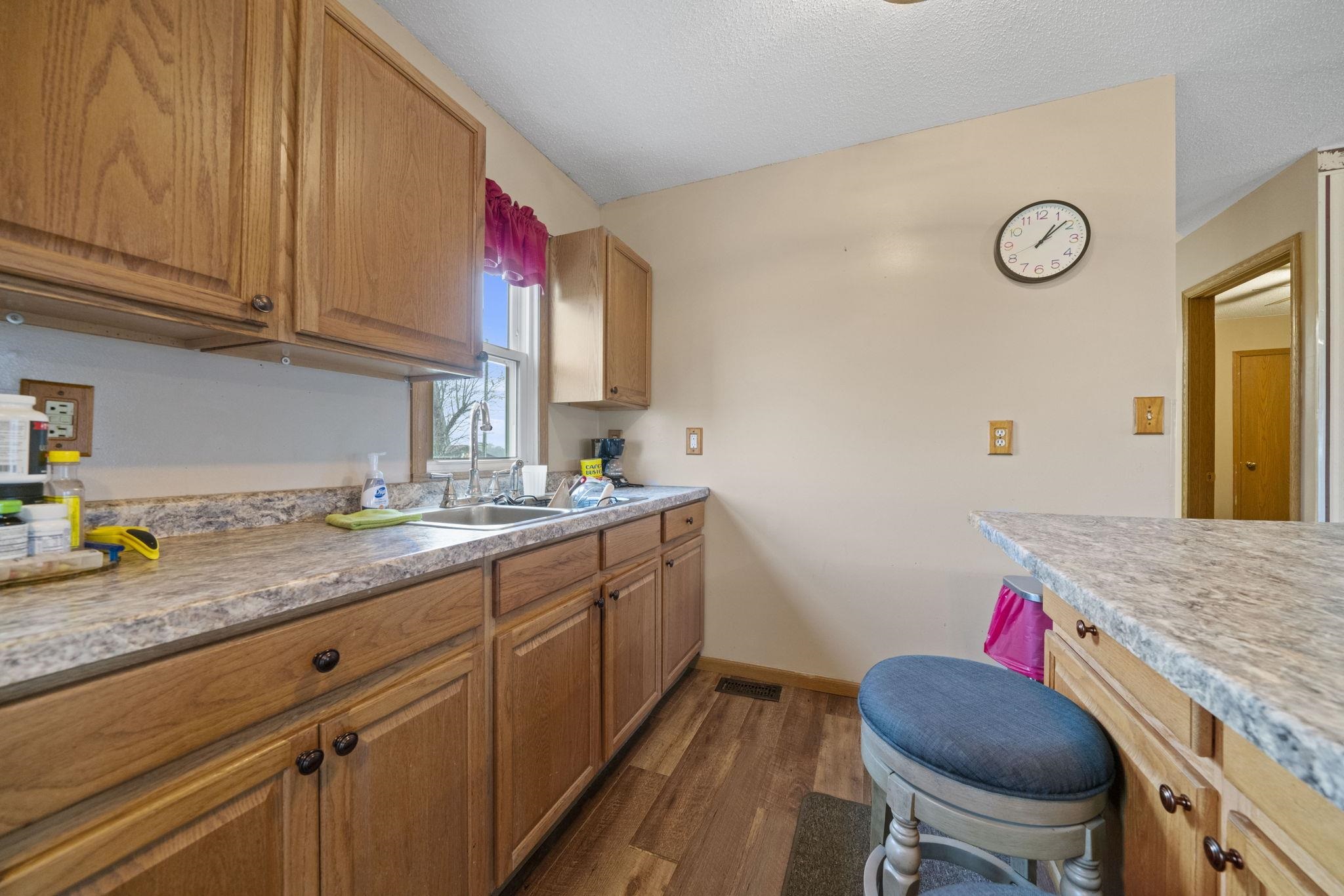 1684 North Mt Morris Road Mount Morris, IL 61054 - Photo 22 of 44 a kitchen with a sink cabinets and stove