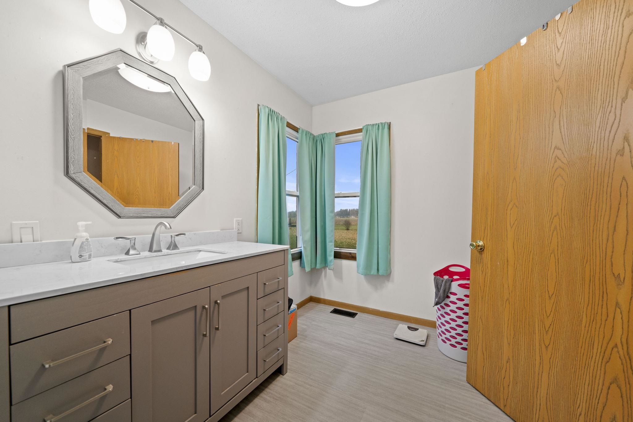 1684 North Mt Morris Road Mount Morris, IL 61054 - Photo 25 of 44 a bathroom with a granite countertop sink and a mirror