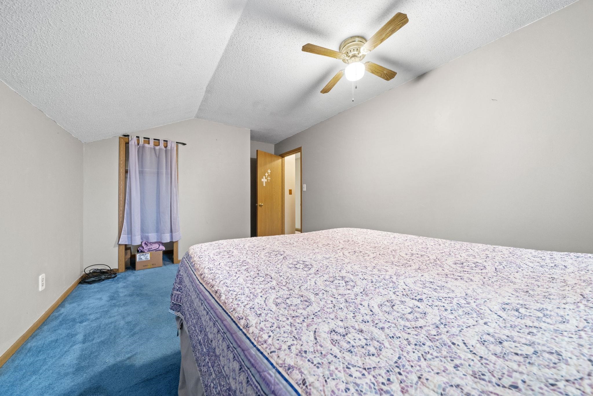 1684 North Mt Morris Road Mount Morris, IL 61054 - Photo 29 of 44 a bedroom with a bed and a chandelier