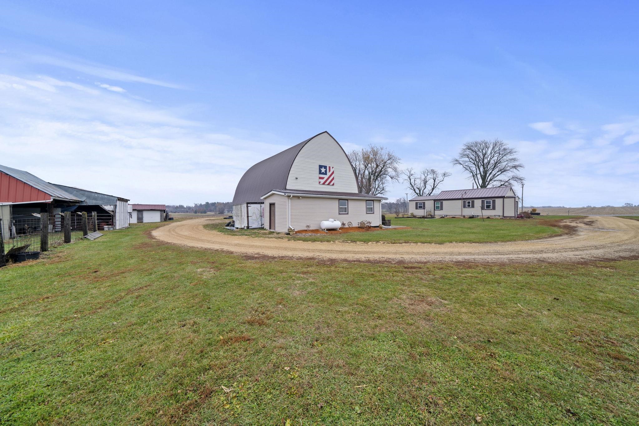 1684 North Mt Morris Road Mount Morris, IL 61054 - Photo 40 of 44 a view of a house with a big yard and large trees