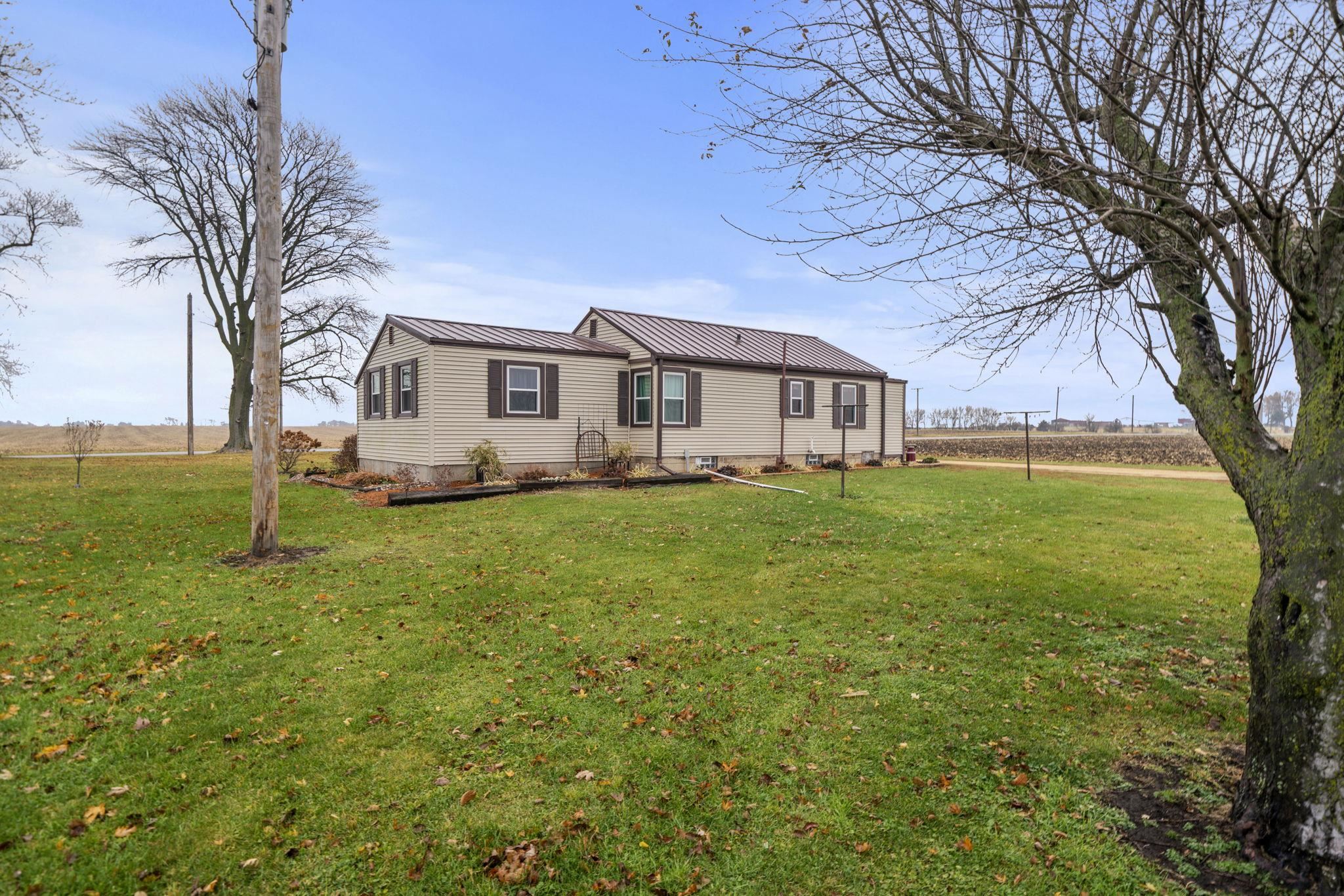 1684 North Mt Morris Road Mount Morris, IL 61054 - Photo 10 of 44 a white house that has a tree in front of it