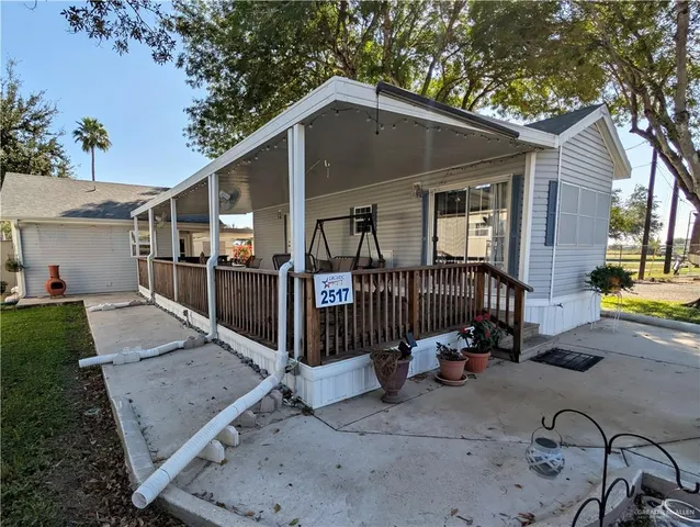 a view of a chair and table in backyard of the house