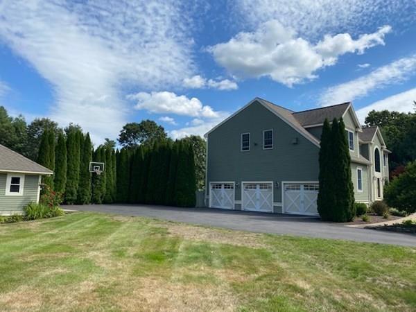 32 Farm Road Bolton, MA 01740 - Photo 3 of 30 a front view of a house with a garden and trees