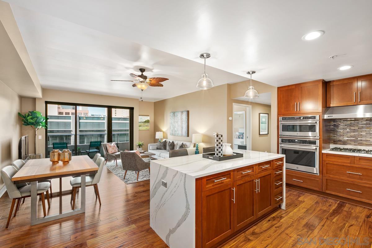 a room with a table chairs and wooden floor