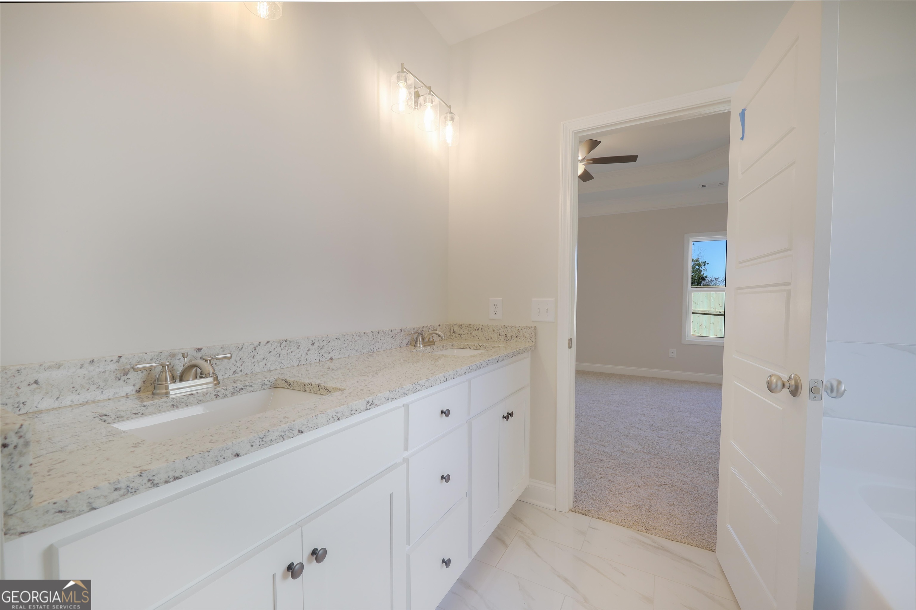 230 Delightful Way, Unit 23 Winder, GA 30680 - Photo 16 of 26 a bathroom with a granite countertop sink and a mirror