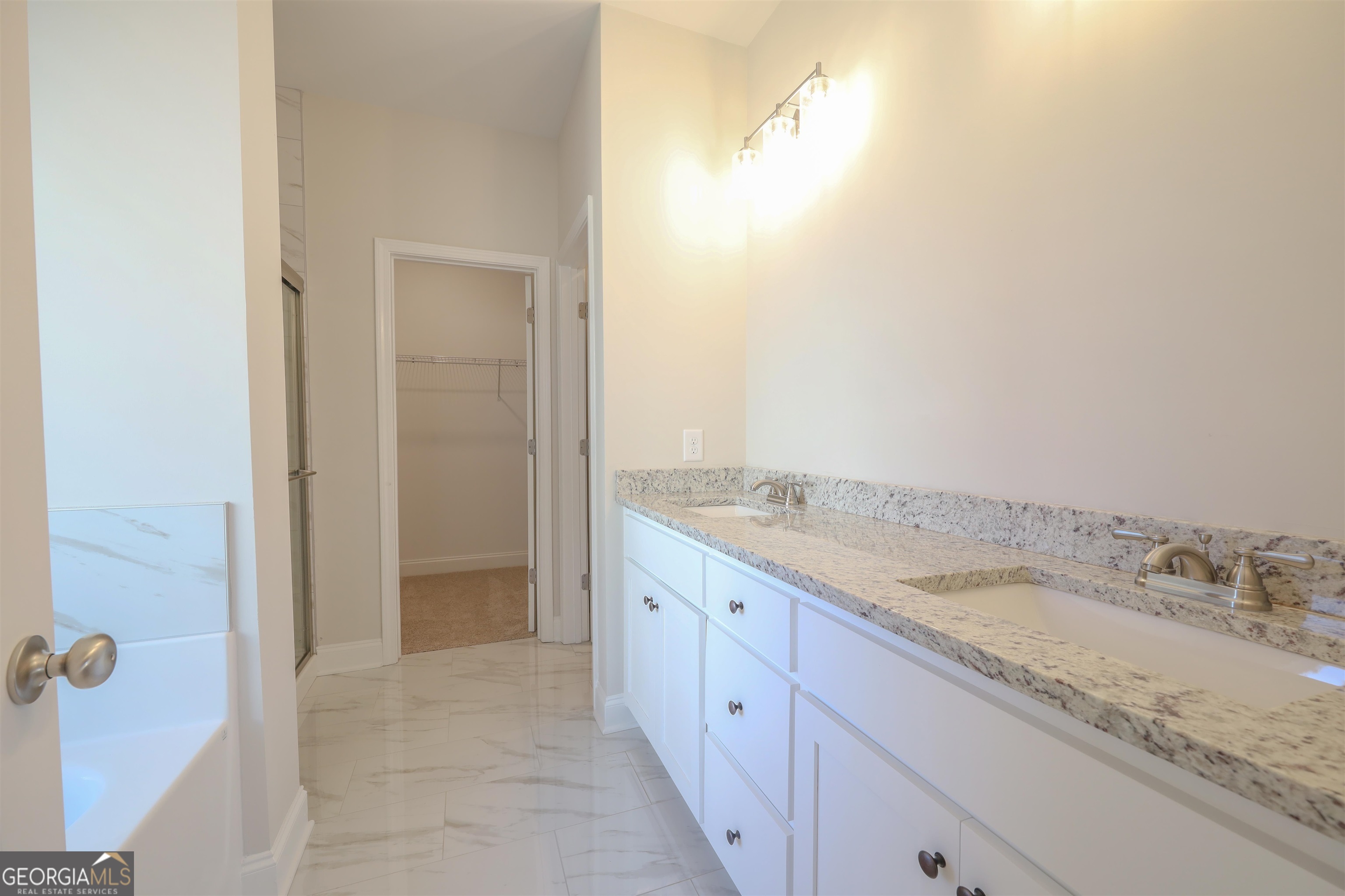 230 Delightful Way, Unit 23 Winder, GA 30680 - Photo 17 of 26 a bathroom with a granite countertop sink and a mirror