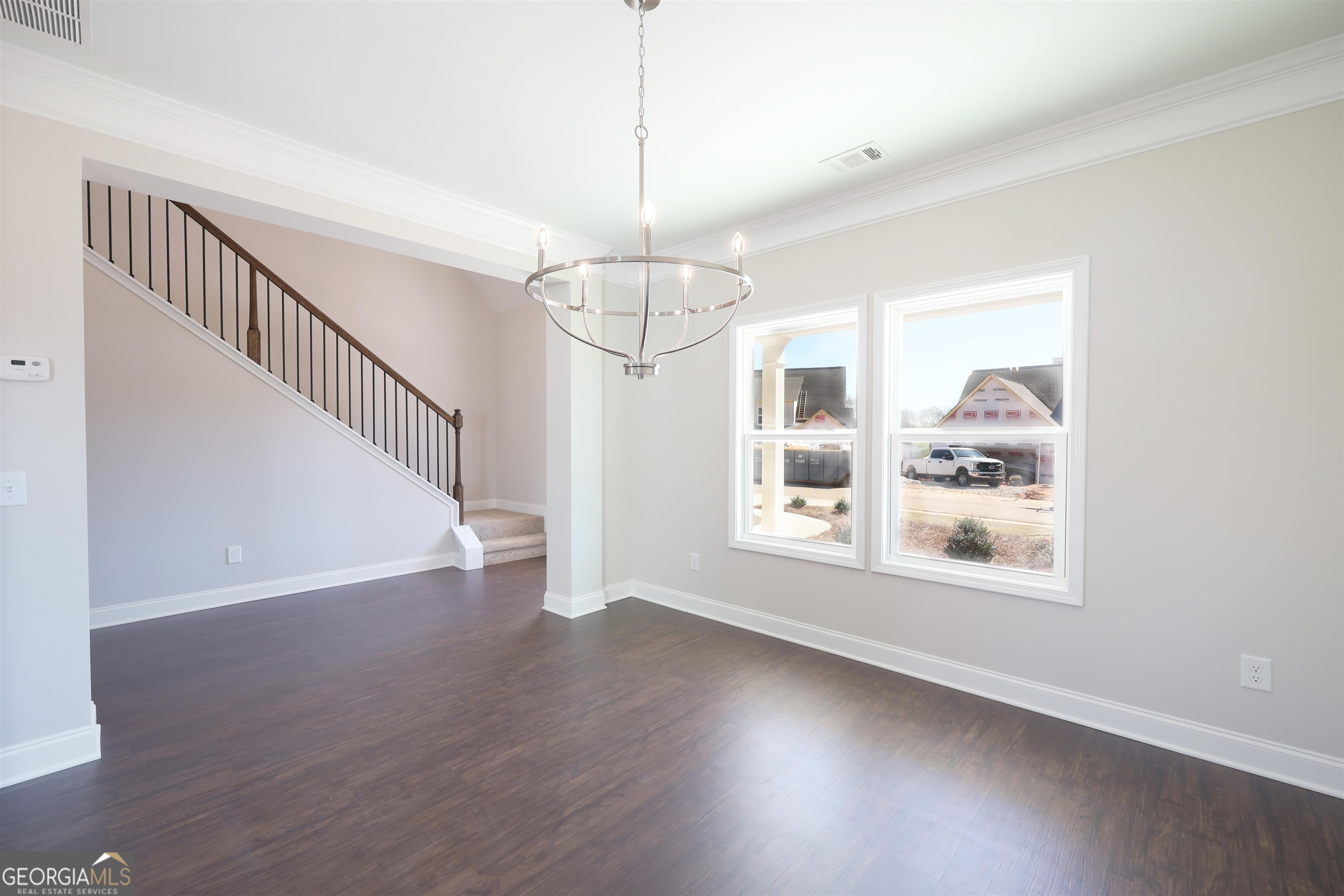 230 Delightful Way, Unit 23 Winder, GA 30680 - Photo 2 of 26 a view of an empty room with wooden floor and a window