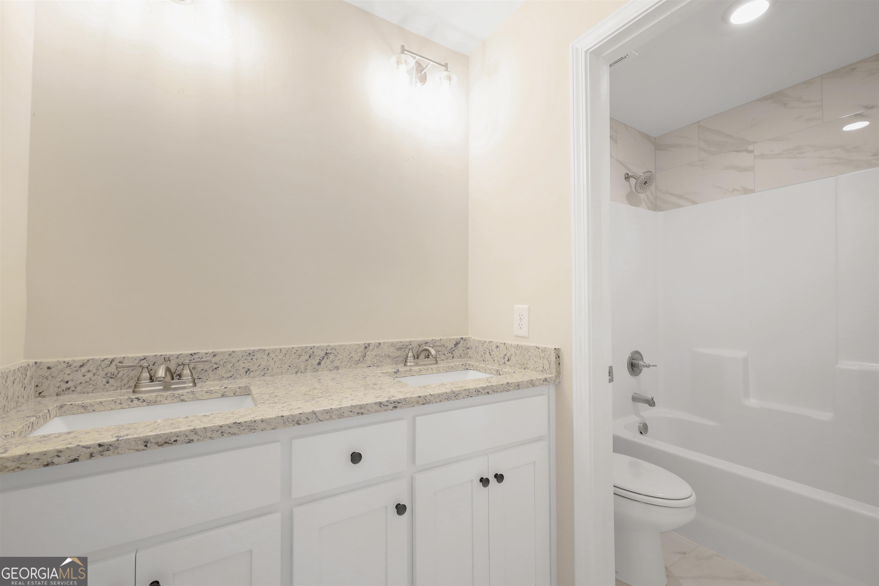 230 Delightful Way, Unit 23 Winder, GA 30680 - Photo 25 of 26 a bathroom with a granite countertop sink and a mirror