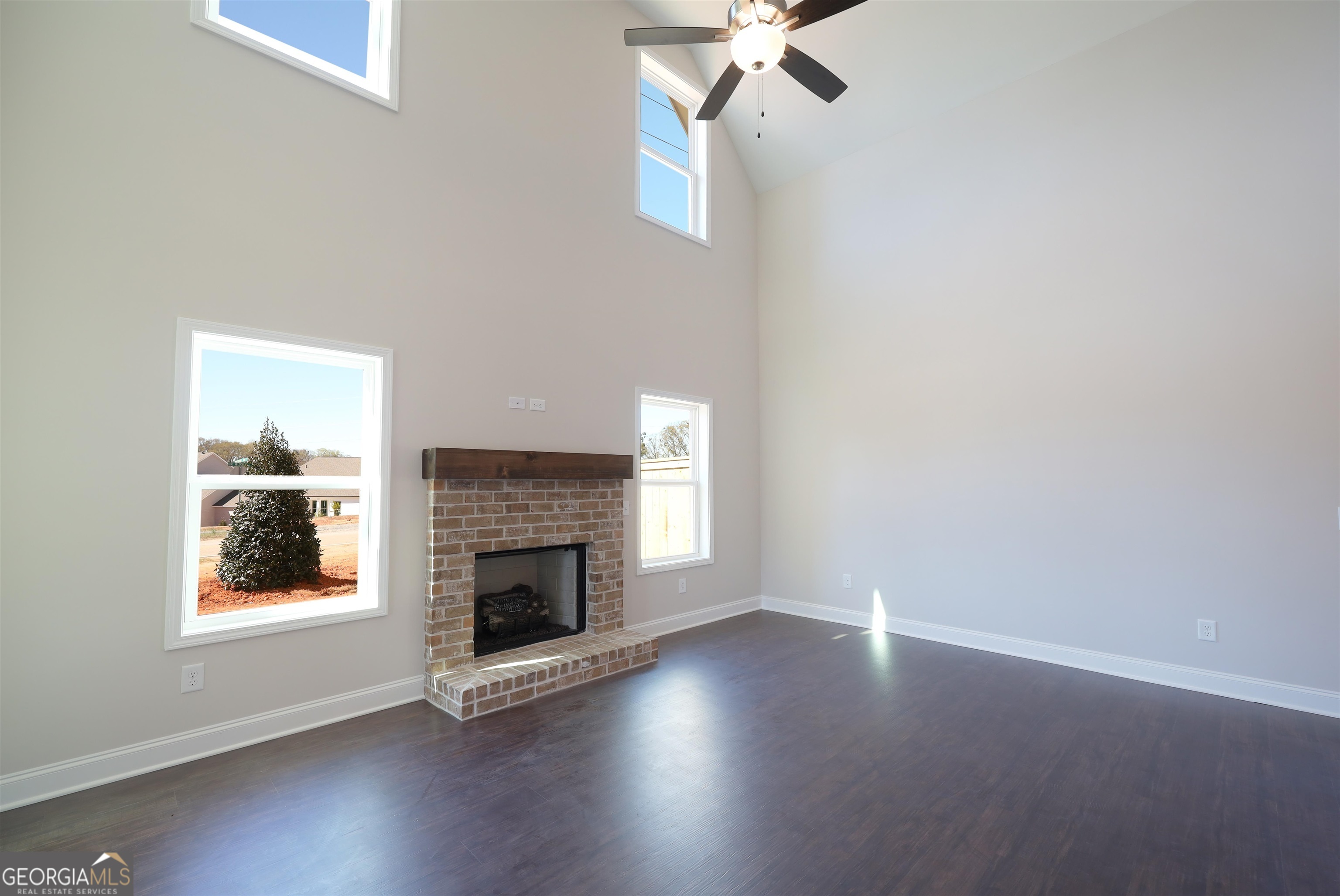 230 Delightful Way, Unit 23 Winder, GA 30680 - Photo 6 of 26 an empty room with windows and fireplace