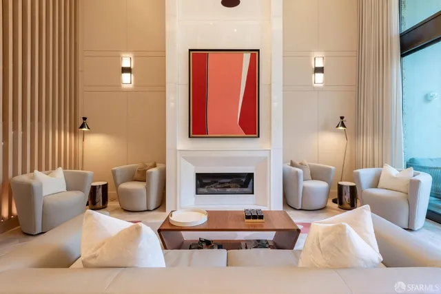 a living room with furniture a fireplace and a chandelier