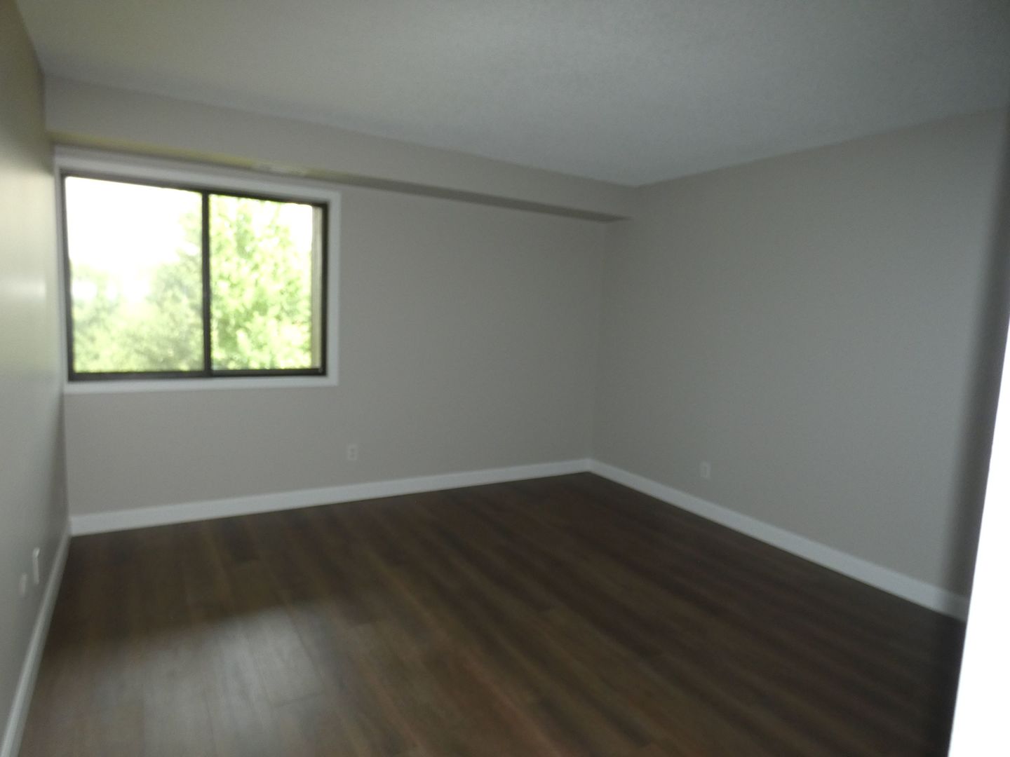 1501 Woodbridge Road, Unit 3C Joliet, IL 60436 - Photo 13 of 24 a view of a big room with wooden floor and windows