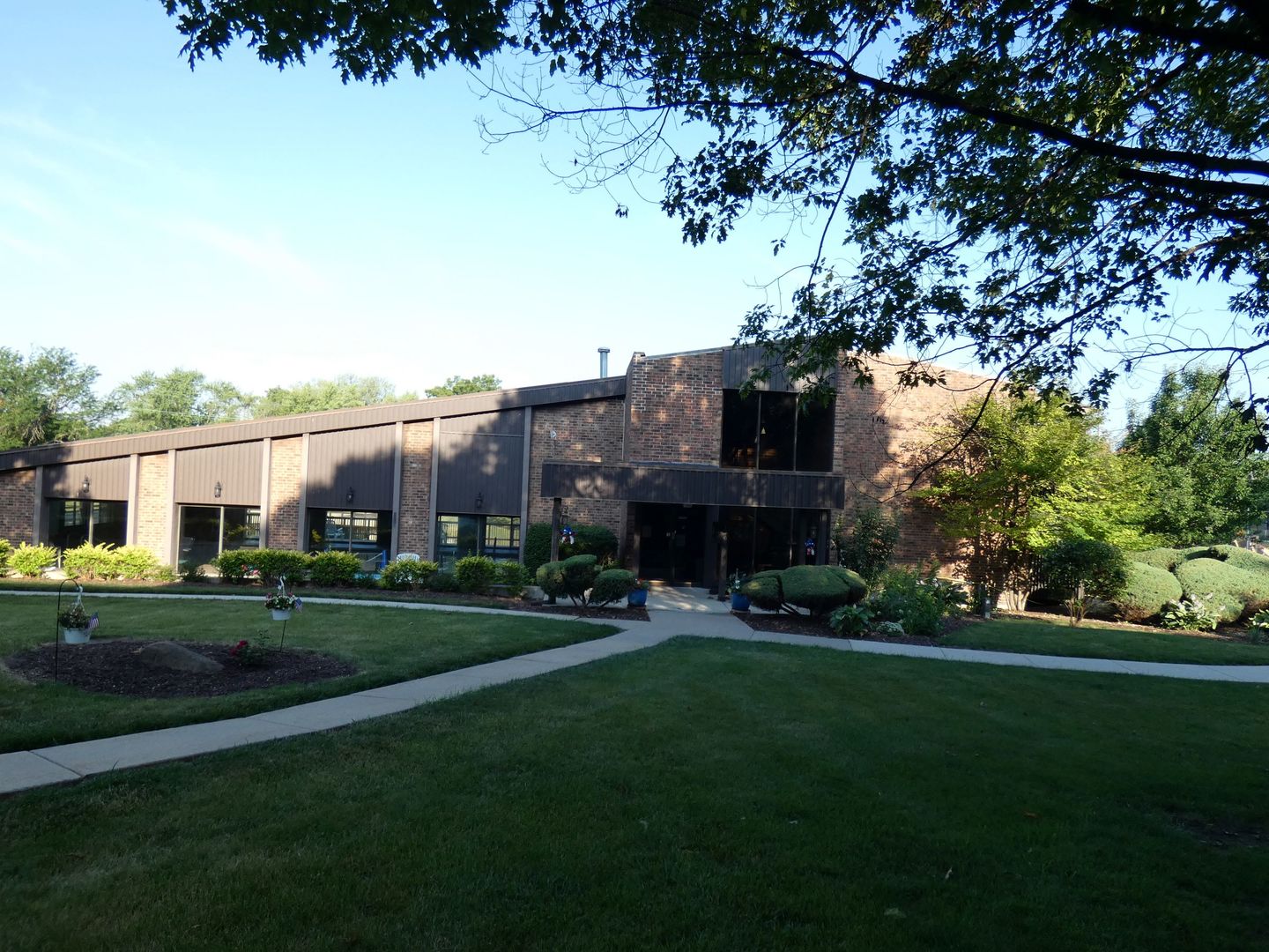 1501 Woodbridge Road, Unit 3C Joliet, IL 60436 - Photo 18 of 24 a view of a big house with a big yard and large trees