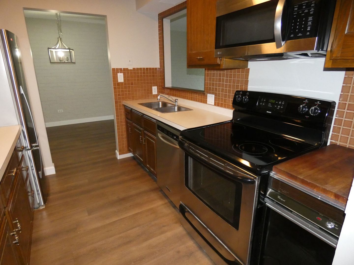 1501 Woodbridge Road, Unit 3C Joliet, IL 60436 - Photo 4 of 24 a kitchen with a stove and a microwave